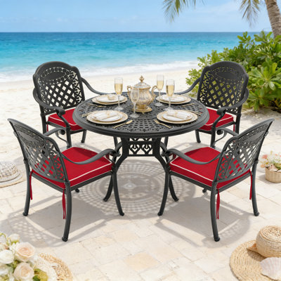 Ensemble de patio 5 pièces en fonte d'aluminium avec coussins toutes saisons, conception empilable et motifs sculptés élégants pour un confort extérieur.
