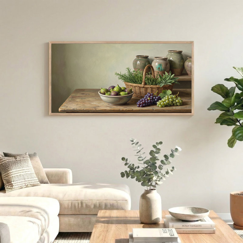 Tableau sur toile représentant un bol de figues et de raisins avec un panier d'herbes aromatiques sur une table en bois.