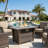 Beth 25" H x 42'' W Outdoor Propane Fire Pit Table with Glass wind guard, lid and Hideaway Gas Tank Seat, 50,000 BTU with Marble Tabletop, Wicker Base
