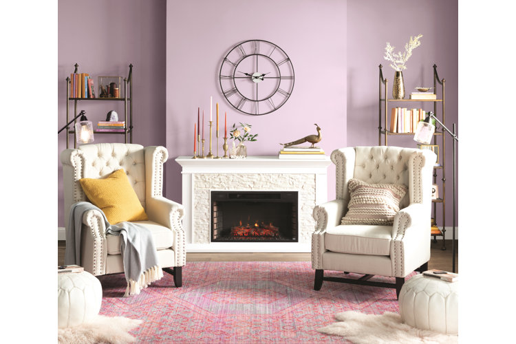 Pink and purple living room color scheme with purple walls and a pink rug.