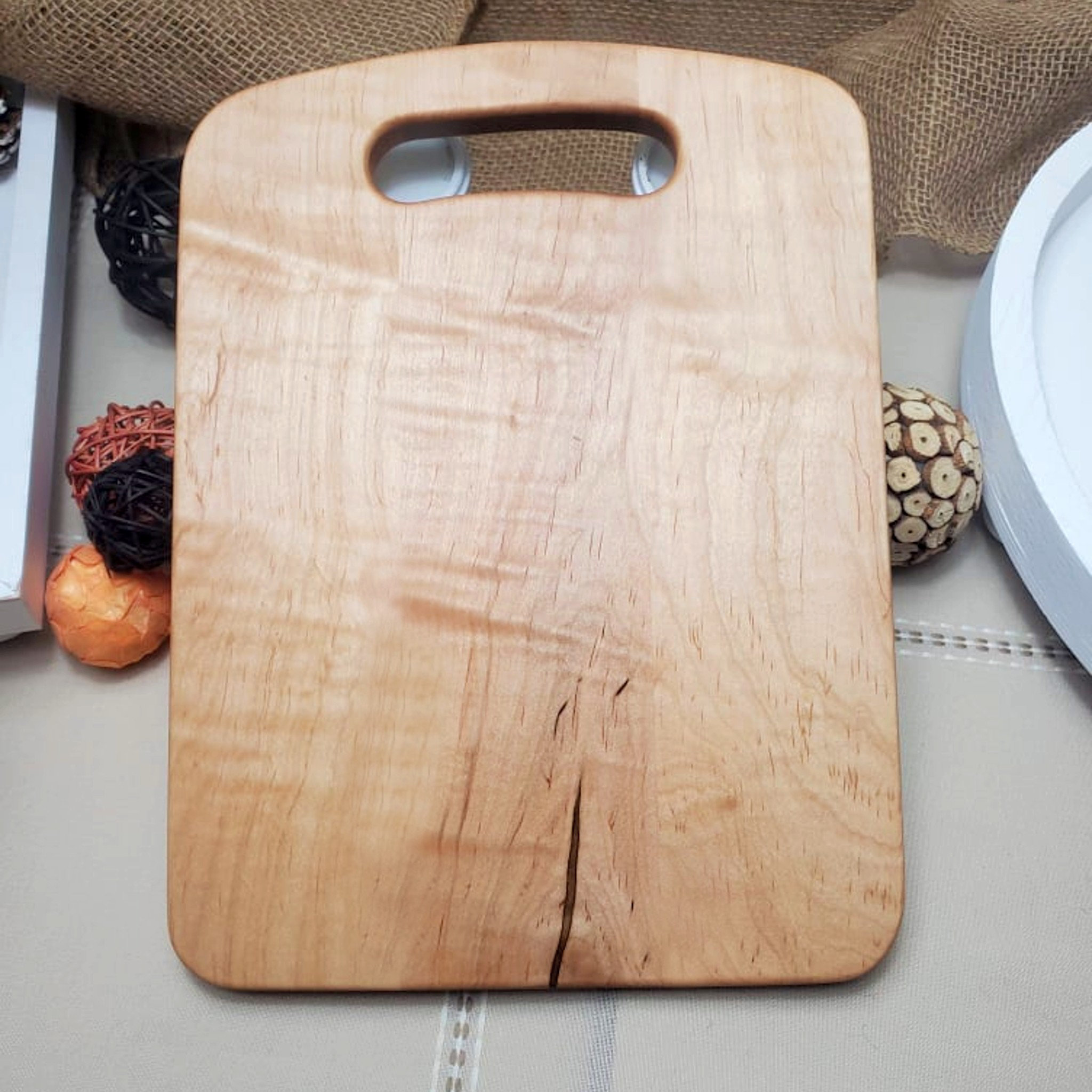 https://assets.wfcdn.com/im/70130678/compr-r85/2458/245880036/solid-curly-maple-cutting-board-with-built-in-handle.jpg