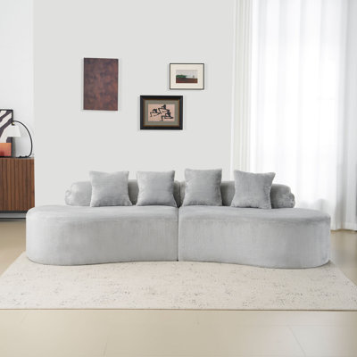 Curved Flannelette Sofa with Multiple Pillows Perfect for Comfort and Stylish Living Room Decor