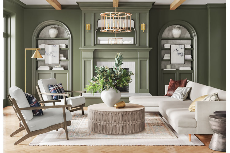 transitional-style living room with sage green walls, white accent chairs, and an ivory sectional