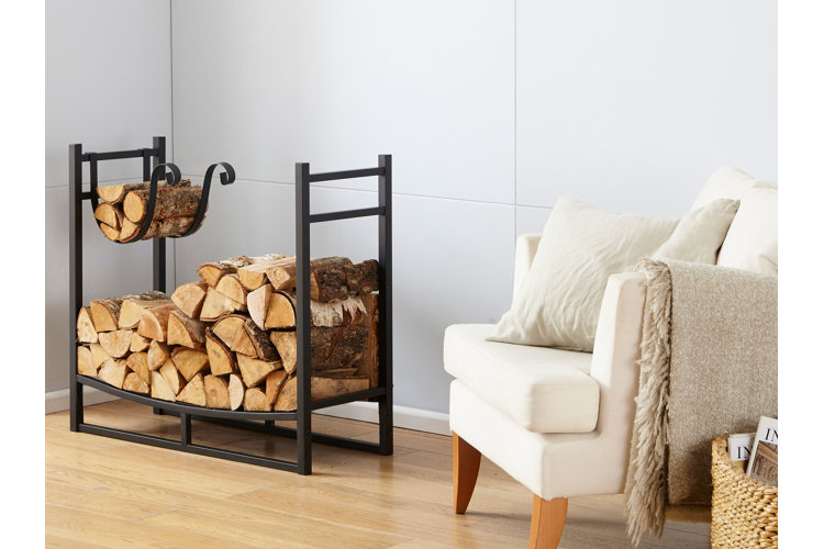 black metal firewood storage rack in a living room with a wood floor. white accent chair with a white throw next to a woven basket