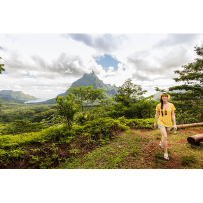 Pretty woman walking on tropical forest