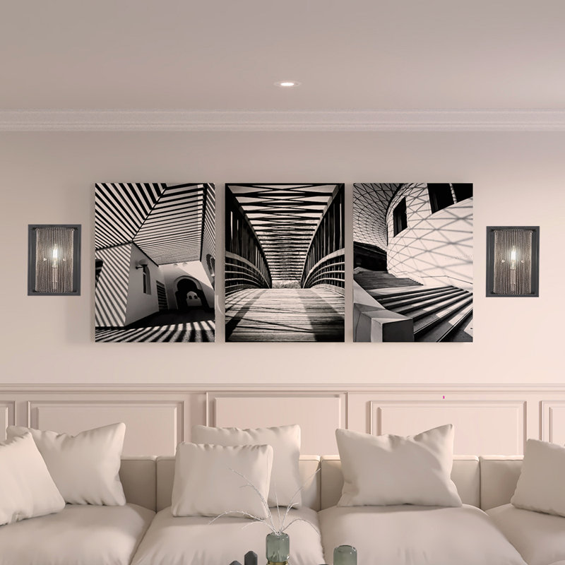 Applique murale Cadina présentée en noir mat et finition nickel brossé