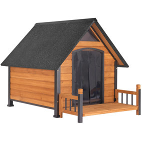Wooden dog house with black roof and covered door.