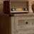 This Light Gray, Washed-Out Sideboard Features A Simple Farmhouse Barn Door Design, Drawers For Storage, And Functions As A Coffee Bar, Making It Suitable For Both Kitchens And Living Rooms.-703361810