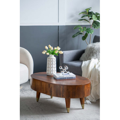 Table basse ovale en bois à quatre pieds