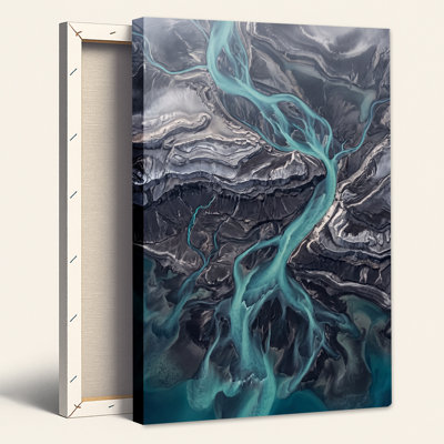 Turquoise Braided River Over Dark Terrain Canvas Wall Art