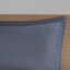 Twin Bedroom With Blue Grey Striped Sheets And Comforter & Round Pillow