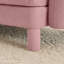 Canapé 3 places en tissu rose avec des pieds cylindriques et distinctifs, confortable pour les séances de lecture