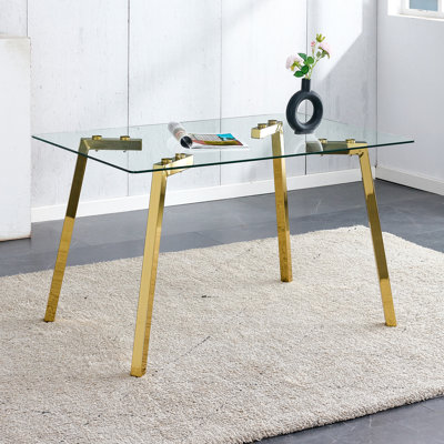 Modern minimalist style rectangular glass dining table with tempered glass tabletop and golden metal legs, suitable for kitchen, dining room, and livi
