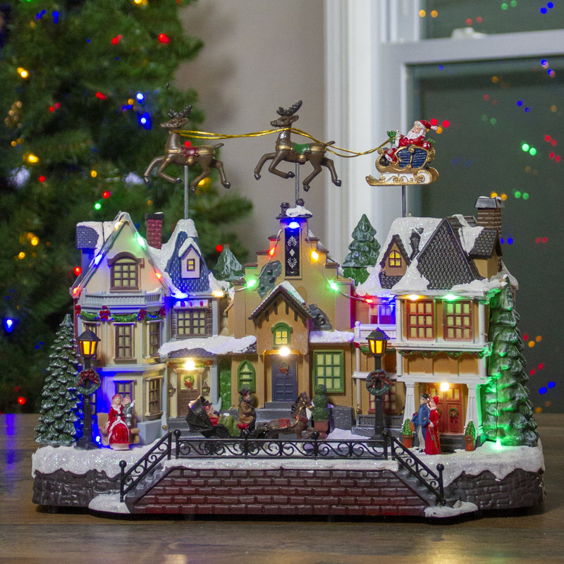 16" White and Brown LED Lighted and Animated Christmas Village with Flying Sleigh Tabletop Decor