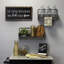 «In this Kitchen We Lick the Spoon», art mural en bois noir