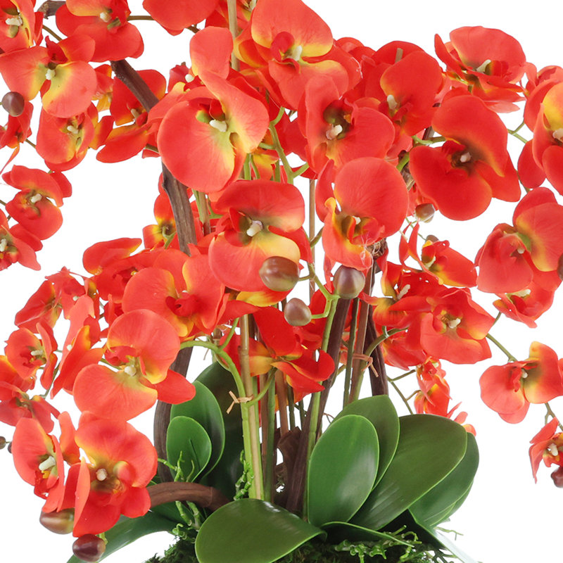 Arrangement de fausses orchidées modernes dans un vase en céramique