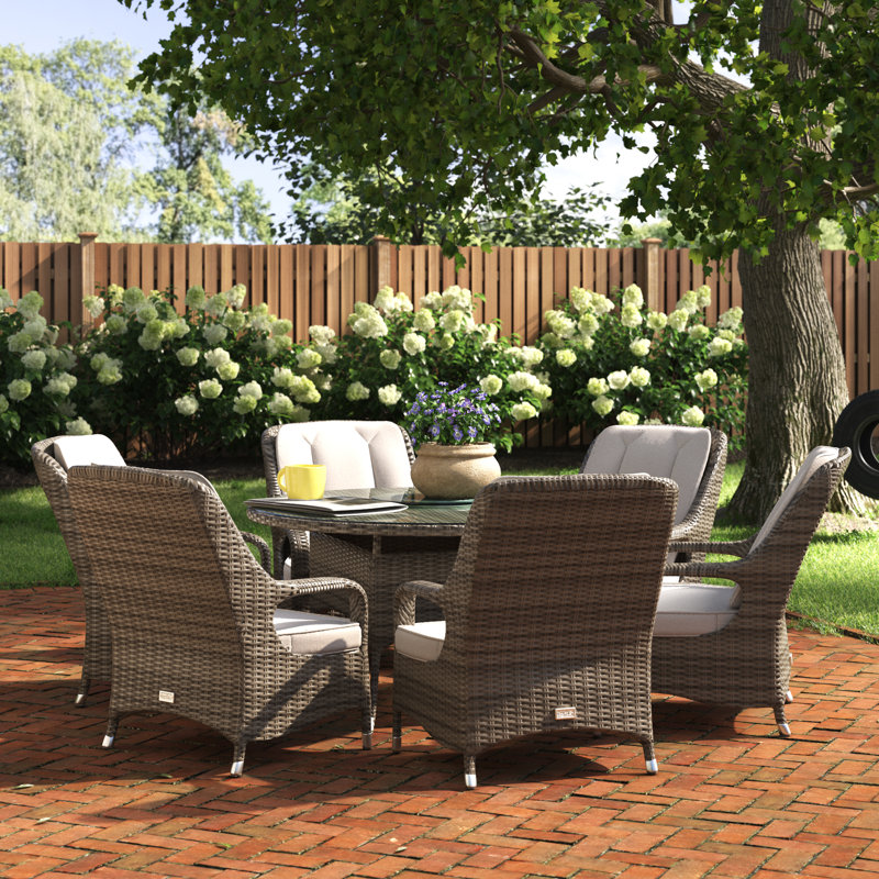 Algird 6 - Person Wicker Patio Dining Set with Round Table , Cushions Included, Brown