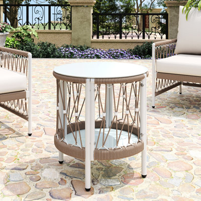 Table d'appoint d'extérieur de 44,4 cm (17,48 po) au charme bohème, plateau en corde tressée et structure thermolaquée pour des moments de détente au bord de la piscine. Finition rouille esthétique. Plateau en verre lisse facile d'entretien.