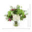 Hortensias et dahlias disposés dans un vase en verre avec fougères
