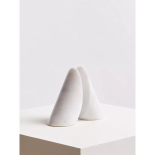 'a pair of marble objects on a white surface'