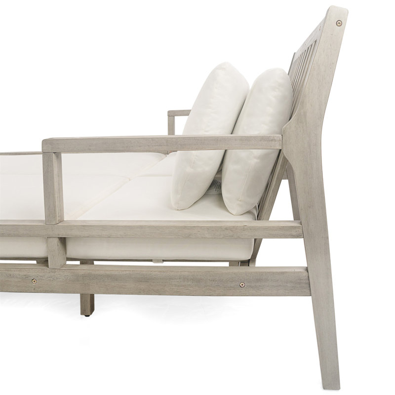 Chaise longue d'extérieur en bois avec accoudoirs confortables et quatre coussins pour la détente