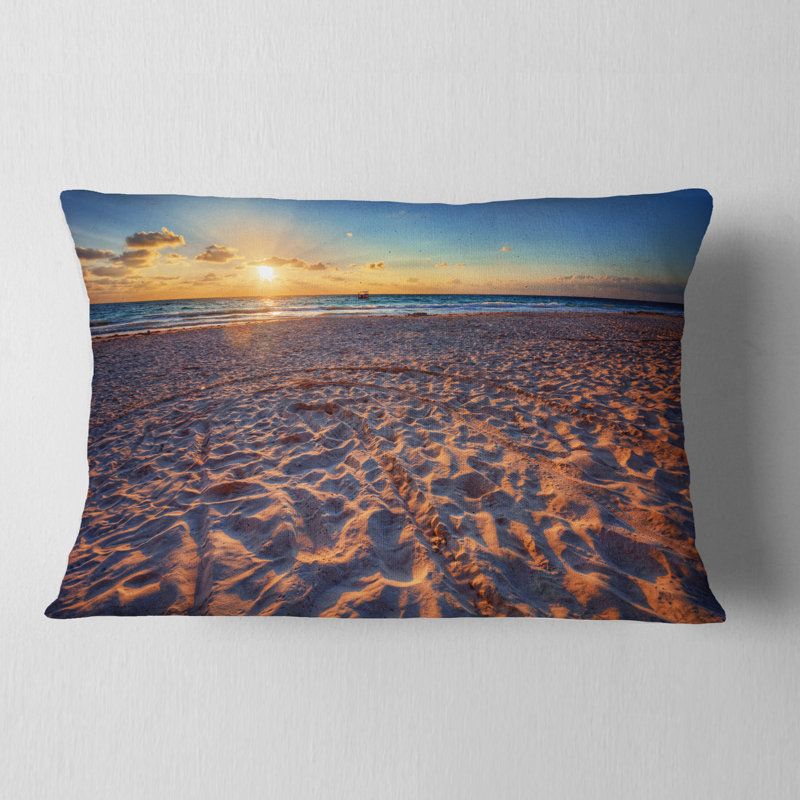Coussin Seashore Trodden Sandy Beach at Sunset