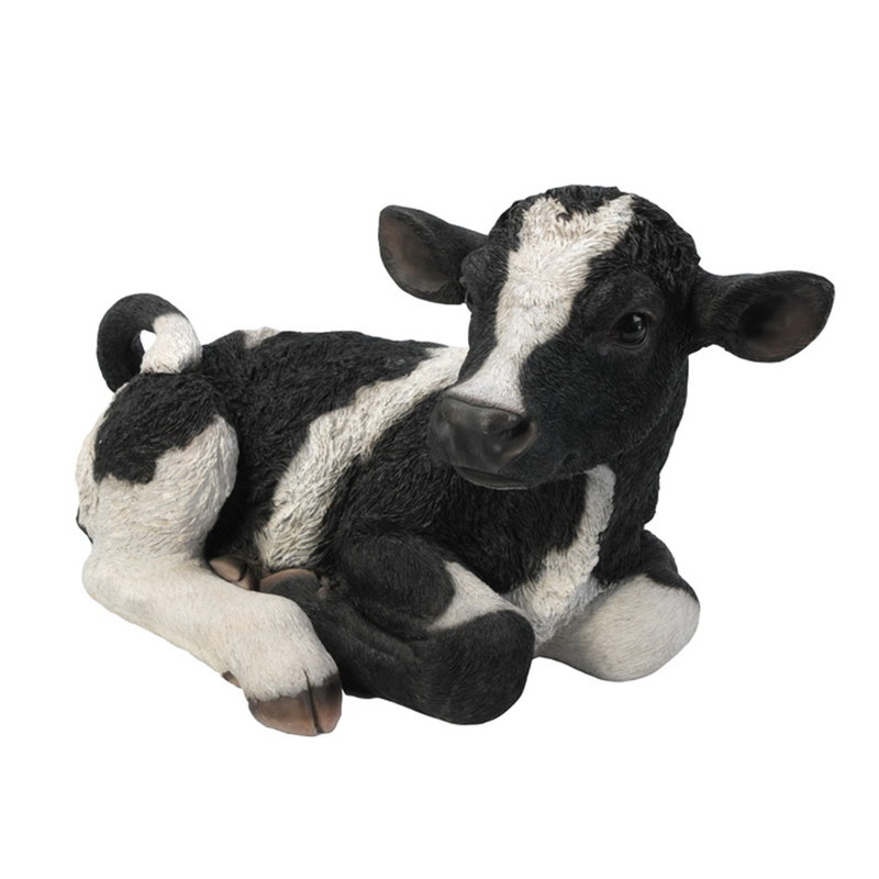 Statue brune et blanche couchée sur une vache, Noir / blanc