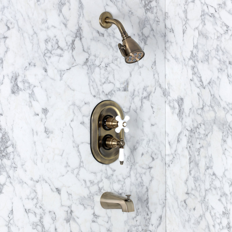 Kingston Brass Restoration Double-Handle 3-Hole Thermostatic Tub and Shower Faucet with Plunger Diverter, Antique Brass