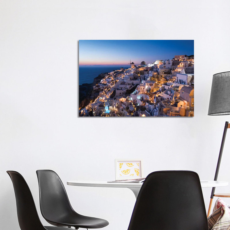 Greece, Santorini. The Village Of Oia Glows In The Post-Sunset Light As The Town'S Lights Add Magic To This Iconic Scene. by Brenda Tharp - Wrapped Canvas Print