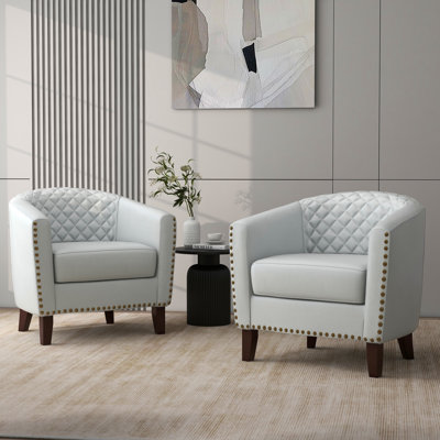 Fauteuil demi-tonneau capitonné en similicuir Edvardas