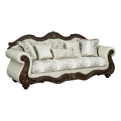 Canapé en tissu beige et finition cerise avec 5 coussins