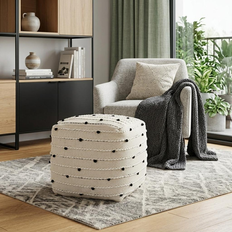 Pouf ottoman de 40 cm en coton et laine à pois noirs, crème et blancs, 40 cm de profondeur.