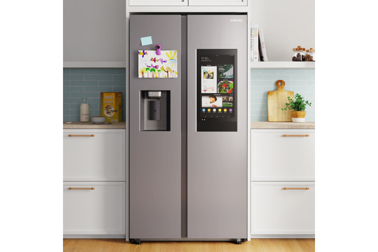 Kitchen with a stainless steel side-by-side refrigerator tucked in between white cabinetry.