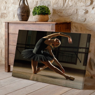 Canvas A Graceful Ballet Dancer Performs An Elegant Pose In A Wall Art Dimly Lit Studio Showcasing Her Fluid Movements And Poise She Canvas Wall Art