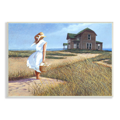 Femme debout sur une brise de vent, lointain, maison de plage par Tom Mielko