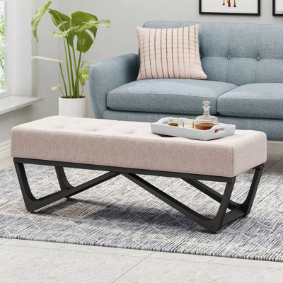 Élégant banc avec structure en tissu et pieds gracieux avec pieds capitonnés en faux bois