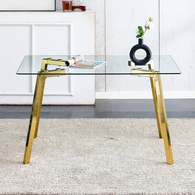 Table de salle à manger rectangulaire avec surface en verre trempé et pieds en métal doré, objet intérieur moderne au goût minimaliste