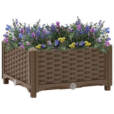 Bac à fleurs surélevé avec jardinière en rotin
