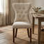 Ensemble de salle à manger rond 3 pièces en hévéa beige clair, tissu lin, avec table à pied centrale et chaises Parson capitonnées.