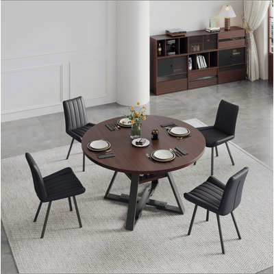 Round dining table in black walnut, 115cm.