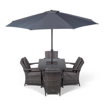 Karas 4 - Person Wicker Patio Dining Set with Square Table , Cushions Included