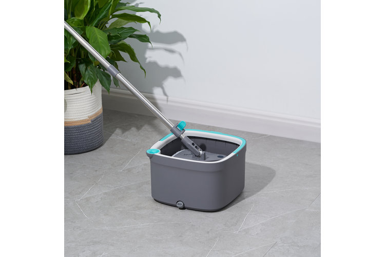 gray mop and bucket inside of a kitchen with a tiled floor