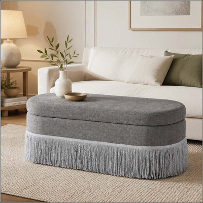 Repose-pieds ovale rembourré avec rangement à franges et couvercle relevable
