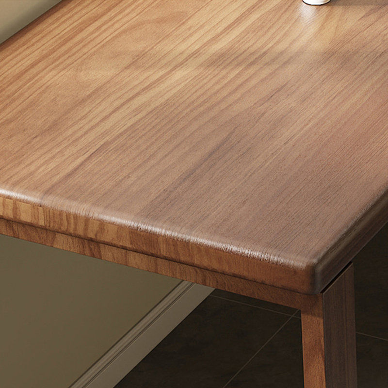 A simple rectangular solid wood desk in walnut color, 29.53" H x 62.99" W x 23.62" D