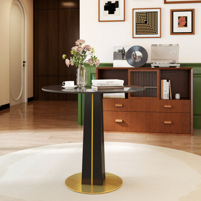 Table ronde avec plateau en verre trempé, pieds en bois noir et base en métal doré