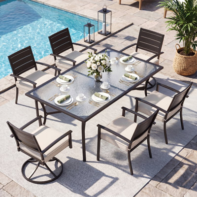 Ensemble repas d'extérieur 7 pièces Kitson, table en verre texturé extra longue avec chaises pivotantes à 360 °, structure renforcée et coussins en oléfine résistants à la décoloration