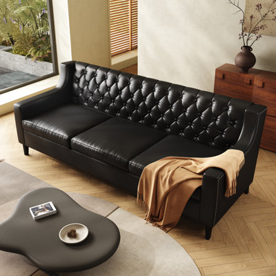 Canapé en cuir noir de 200 cm (78,75 po) avec assise profonde et dossier capitonné, style Chesterfield classique vintage pour salon ou bureau.