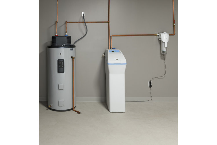 two large water heaters next to one another in a basement