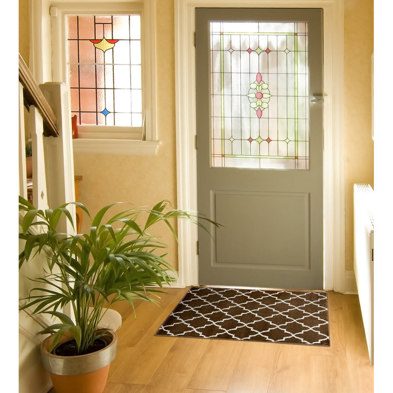 Spiceland Floral Polypropylene Area Rug in Brown