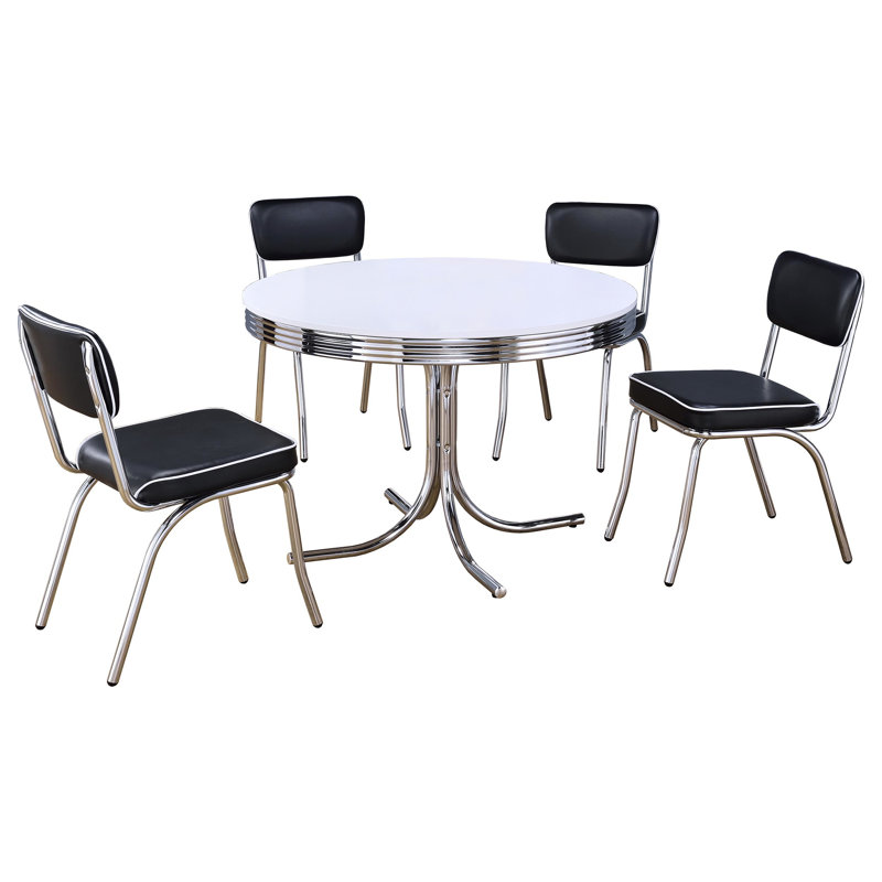 Table ronde 5 avec table en métal blanc et chaises en tissu noir pour une configuration élégante dans une ambiance rembourrée